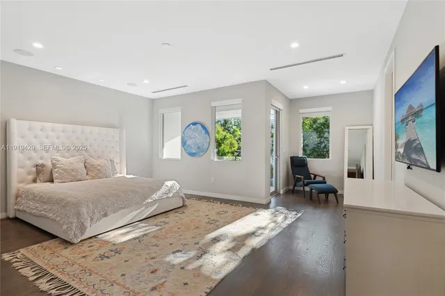 a bedroom with a large bed and a window