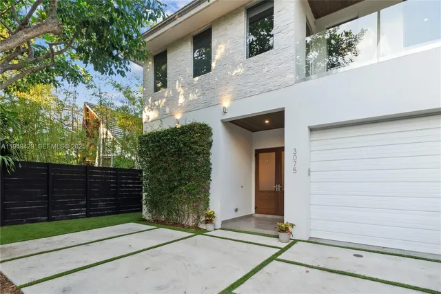 a front view of a house with a garden