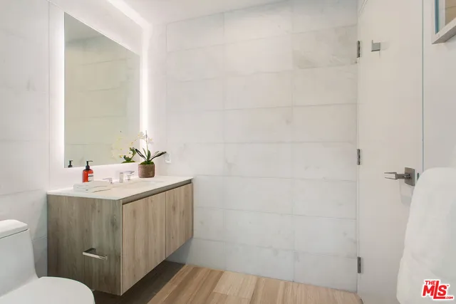 a bedroom with a bed and glass windows