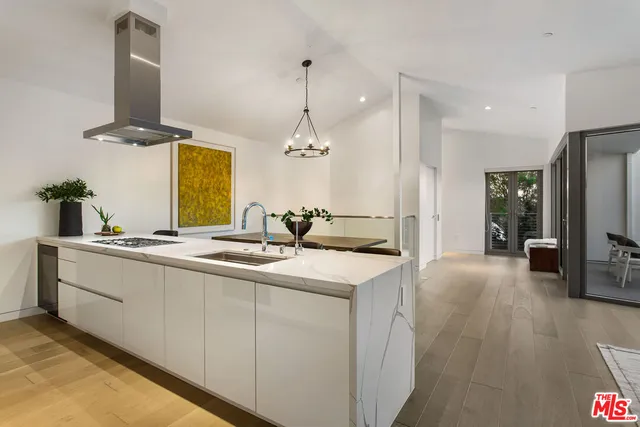 a kitchen with sink and mirror