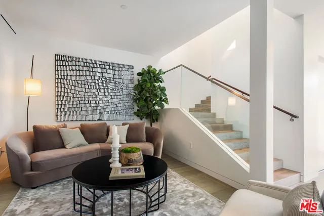 a living room with furniture potted plant and a window