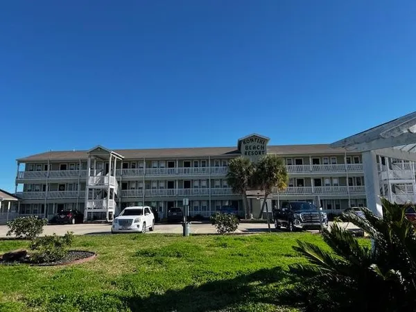 a view of a building with a yard