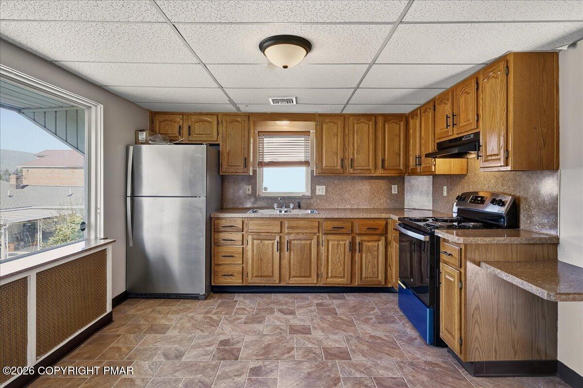 115 Spruce Street Nesquehoning, PA 18240 - Photo 15 of 38 a kitchen with stainless steel appliances granite countertop a refrigerator a stove a sink dishwasher and a refrigerator