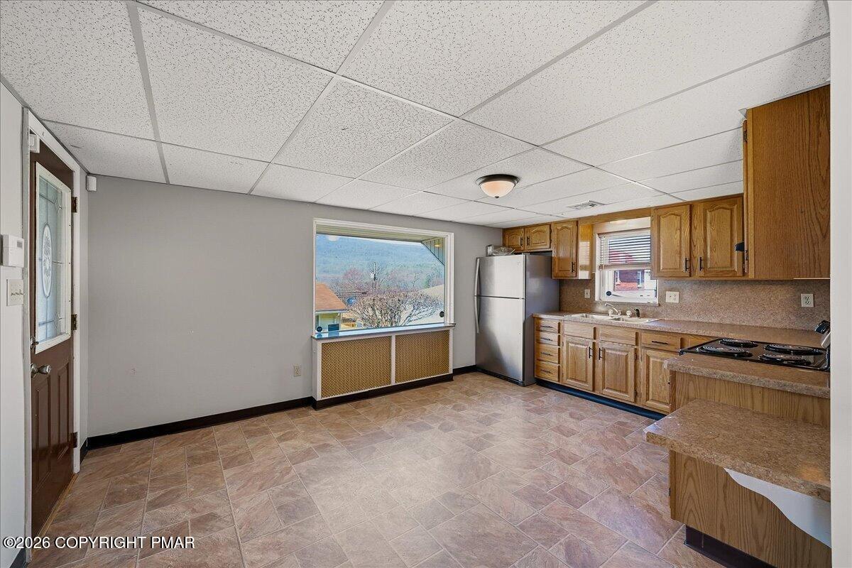 115 Spruce Street Nesquehoning, PA 18240 - Photo 16 of 38 a kitchen with stainless steel appliances a stove top oven a sink a counter space and cabinets