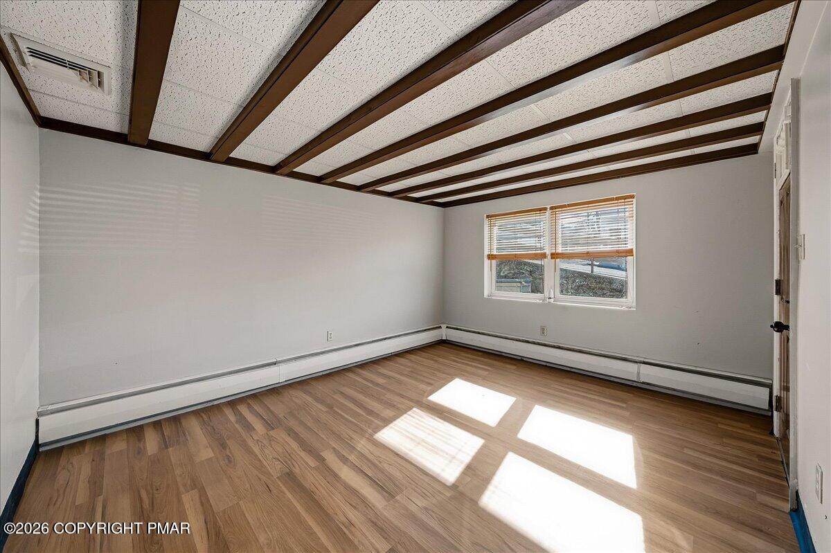 115 Spruce Street Nesquehoning, PA 18240 - Photo 18 of 38 a view of an empty room with wooden floor and a window
