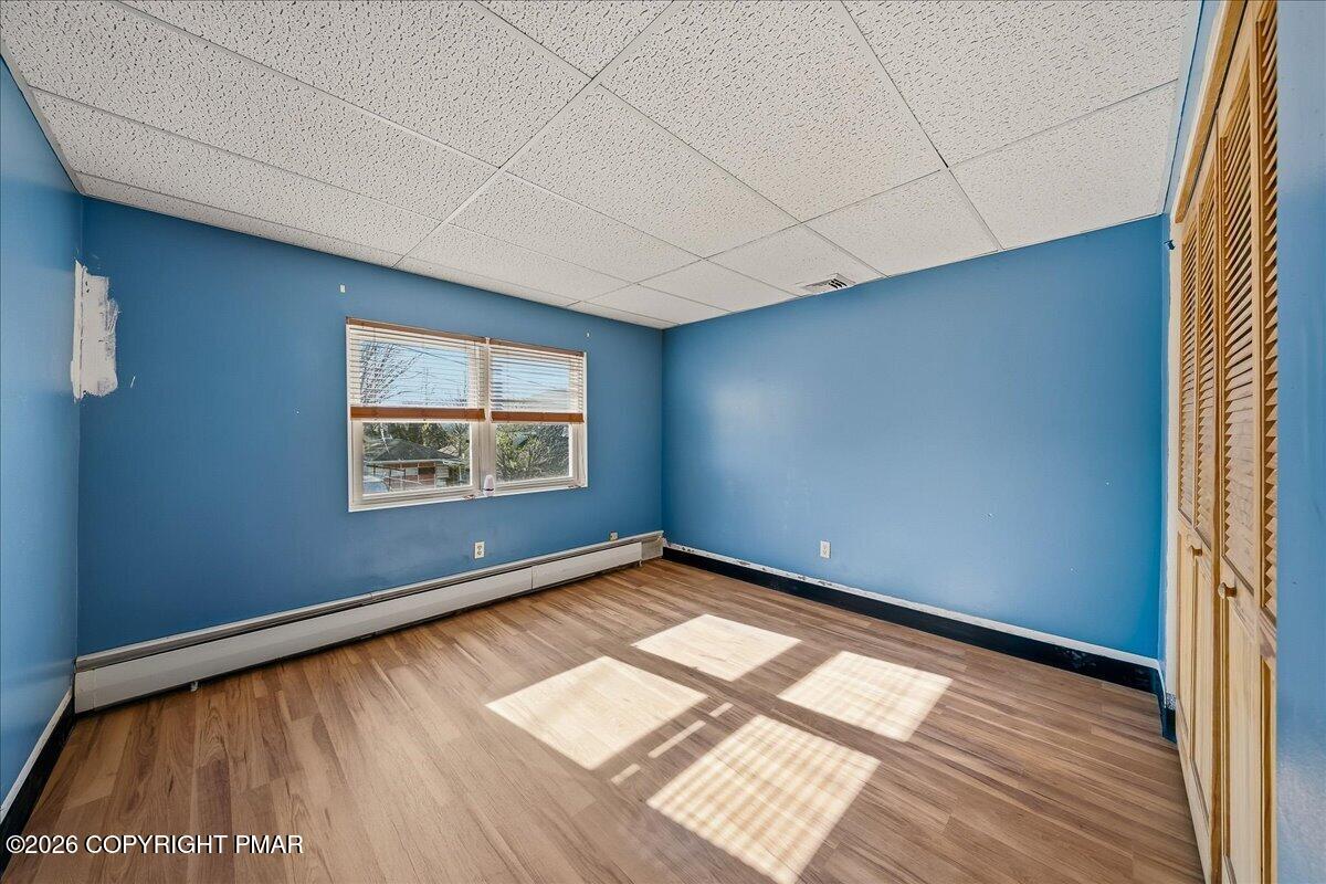 115 Spruce Street Nesquehoning, PA 18240 - Photo 24 of 38 a view of an empty room with a window and wooden floor