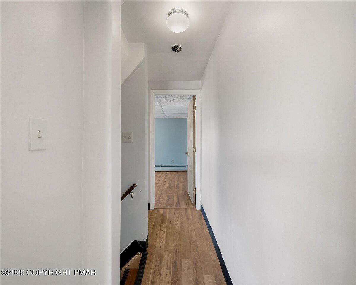 115 Spruce Street Nesquehoning, PA 18240 - Photo 26 of 38 a view of a hallway with wooden floor and staircase