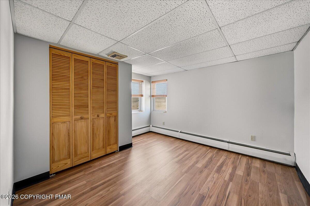 115 Spruce Street Nesquehoning, PA 18240 - Photo 27 of 38 an empty room with wooden floor and windows