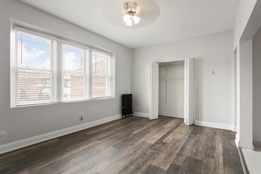 1608 West Sherwin Avenue, Unit 712 Chicago, IL 60626 - Photo 3 of 11 a view of an empty room with wooden floor and a window