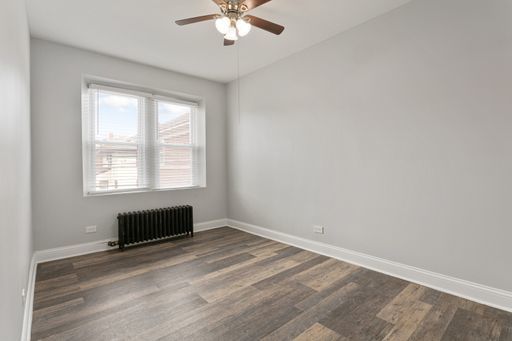 1608 West Sherwin Avenue, Unit 712 Chicago, IL 60626 - Photo 6 of 11 an empty room with a window