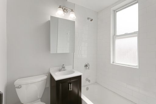 1608 West Sherwin Avenue, Unit 712 Chicago, IL 60626 - Photo 8 of 11 a bathroom with a sink toilet and shower