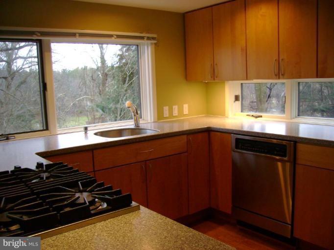 1801 Hatfield Road Huntingtown, MD 20639 - Photo 11 of 19 a kitchen with a sink a stove and a window