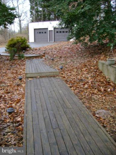 1801 Hatfield Road Huntingtown, MD 20639 - Photo 3 of 19 a view of a terrace with wooden floor and fence