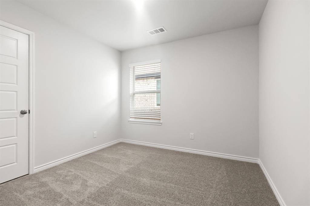 1607 Romans Road Ennis, TX 75119 - Photo 11 of 15 a view of an empty room with a window