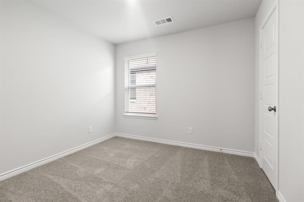 1607 Romans Road Ennis, TX 75119 - Photo 12 of 15 an empty room with windows