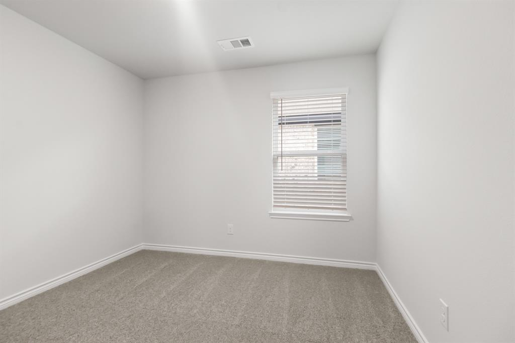 1607 Romans Road Ennis, TX 75119 - Photo 13 of 15 an empty room with a window