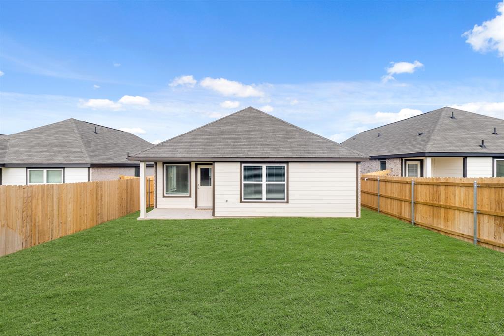 1607 Romans Road Ennis, TX 75119 - Photo 14 of 15 a front view of a house with a yard