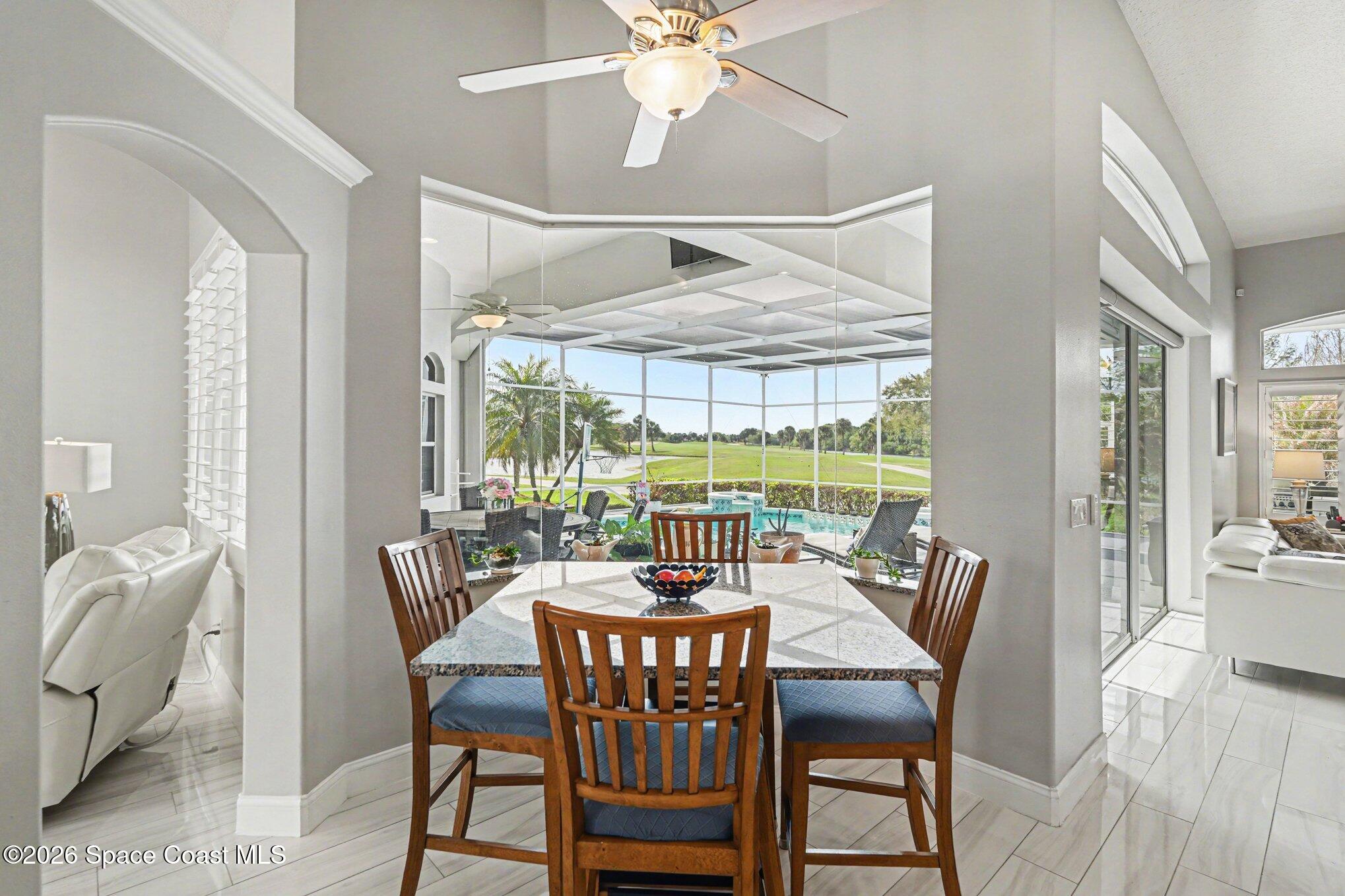 4317 Collingtree Drive Rockledge, FL 32955 - Photo 12 of 64 a dining room with furniture a chandelier and wooden floor