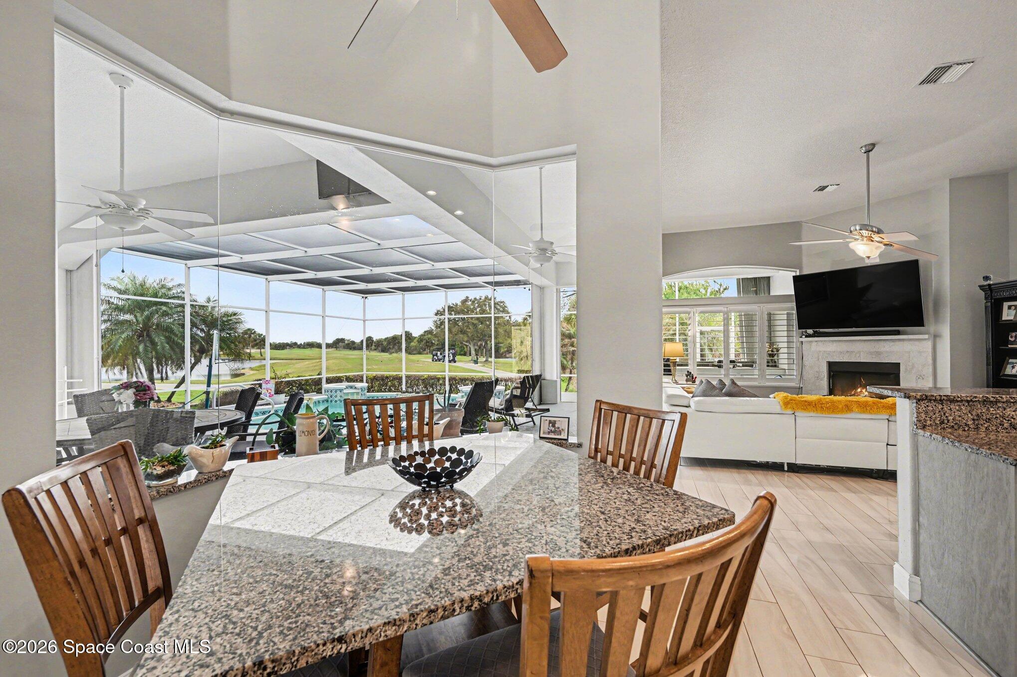 4317 Collingtree Drive Rockledge, FL 32955 - Photo 13 of 64 a dining room with furniture a chandelier and wooden floor