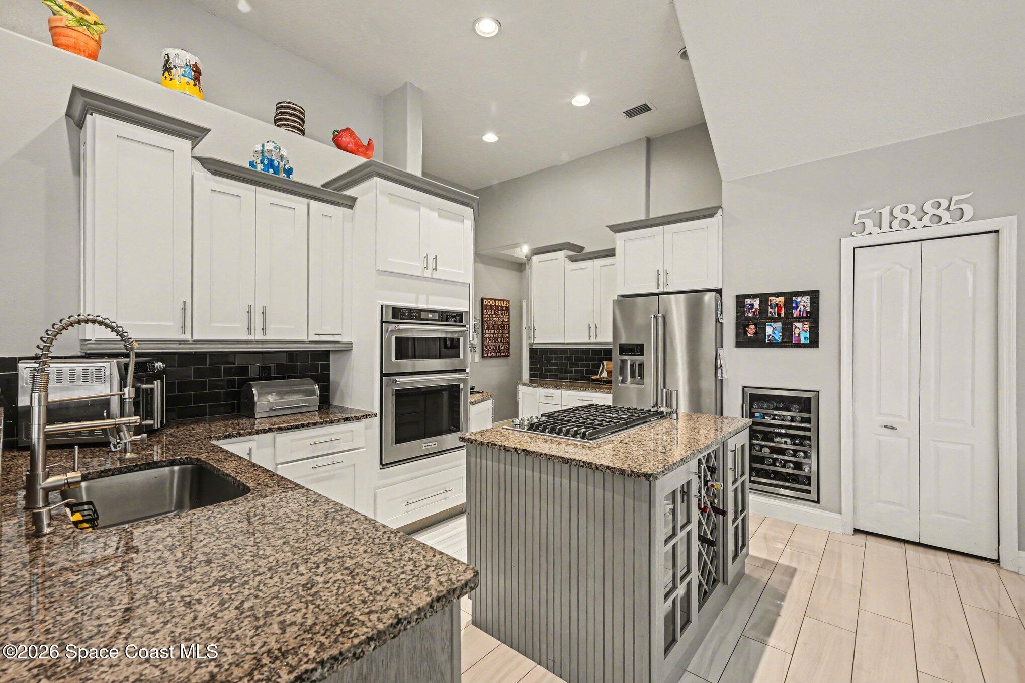 4317 Collingtree Drive Rockledge, FL 32955 - Photo 15 of 64 a kitchen with stainless steel appliances granite countertop a sink stove and refrigerator