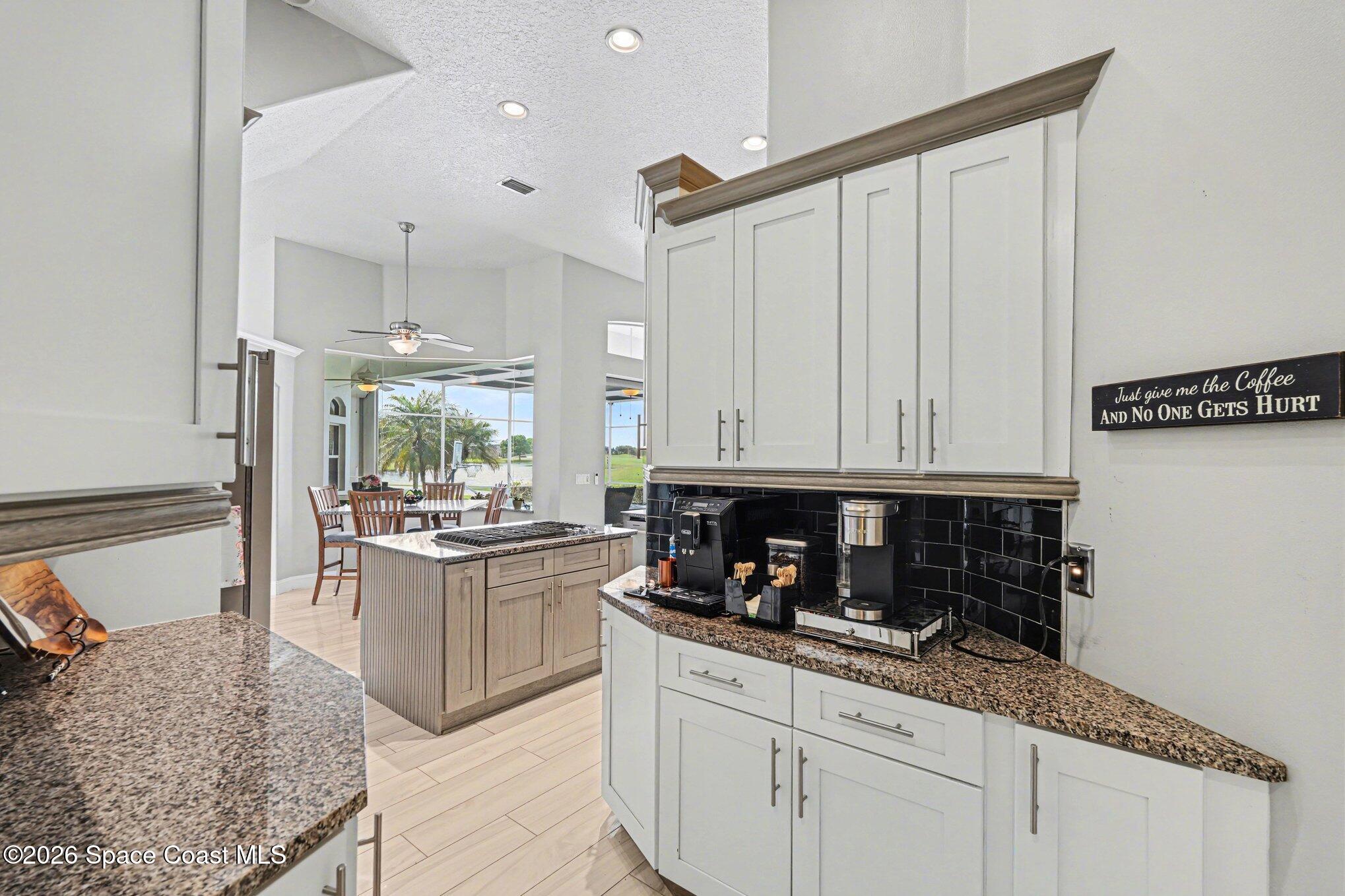 4317 Collingtree Drive Rockledge, FL 32955 - Photo 21 of 64 a kitchen with stainless steel appliances granite countertop a stove a sink and a refrigerator