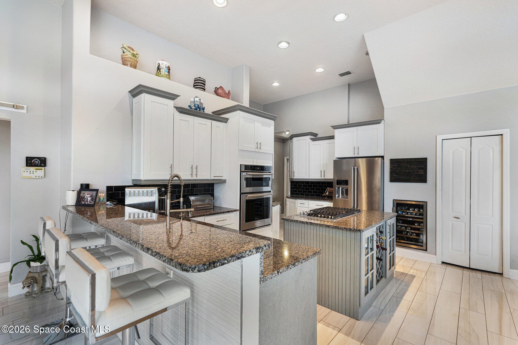 4317 Collingtree Drive Rockledge, FL 32955 - Photo 22 of 64 a kitchen with stainless steel appliances granite countertop a sink and a refrigerator