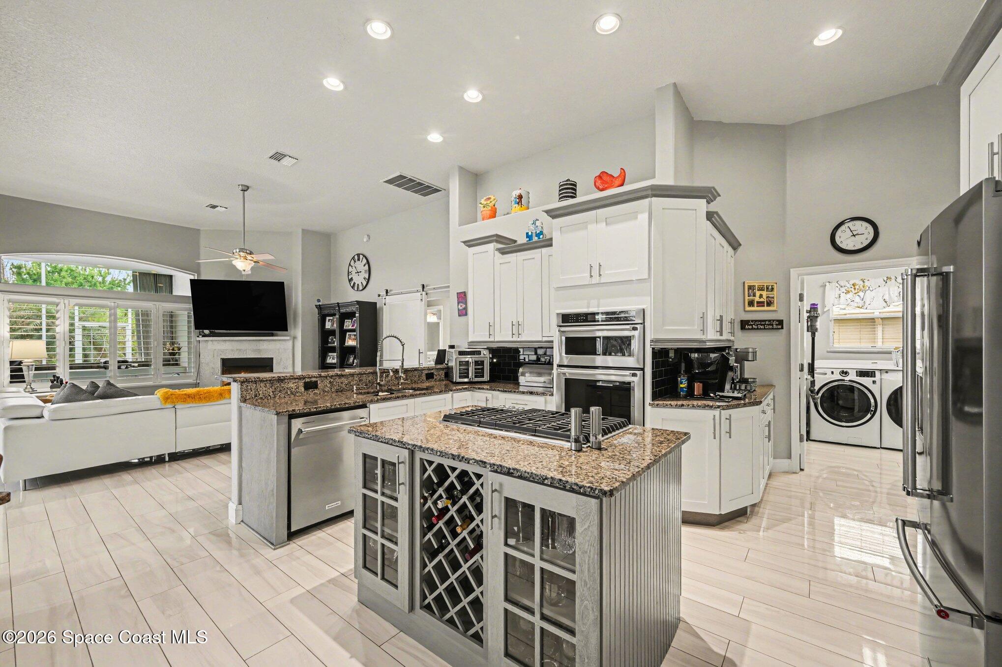 4317 Collingtree Drive Rockledge, FL 32955 - Photo 23 of 64 a kitchen with stainless steel appliances granite countertop a stove and a sink