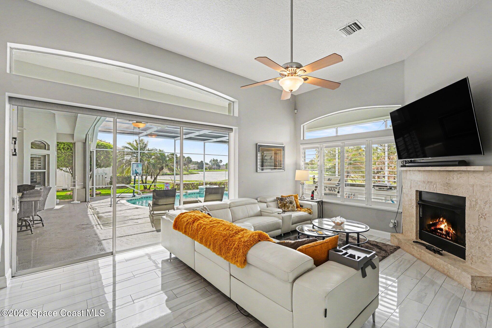 4317 Collingtree Drive Rockledge, FL 32955 - Photo 24 of 64 a living room with fireplace furniture and a flat screen tv