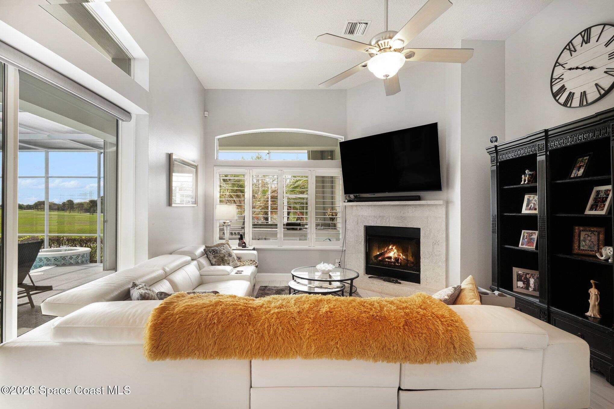 4317 Collingtree Drive Rockledge, FL 32955 - Photo 25 of 64 a living room with furniture a fireplace and a flat screen tv