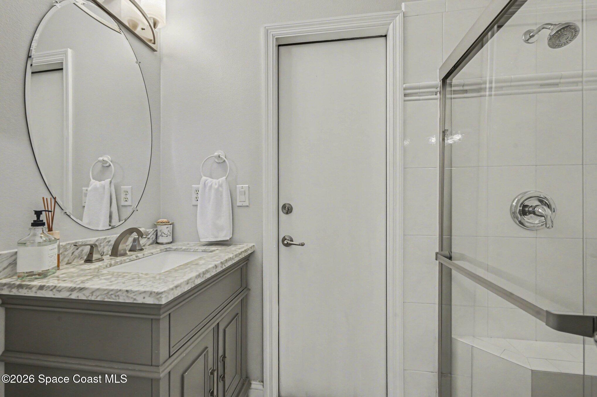 4317 Collingtree Drive Rockledge, FL 32955 - Photo 29 of 64 a bathroom with a granite countertop sink and a mirror