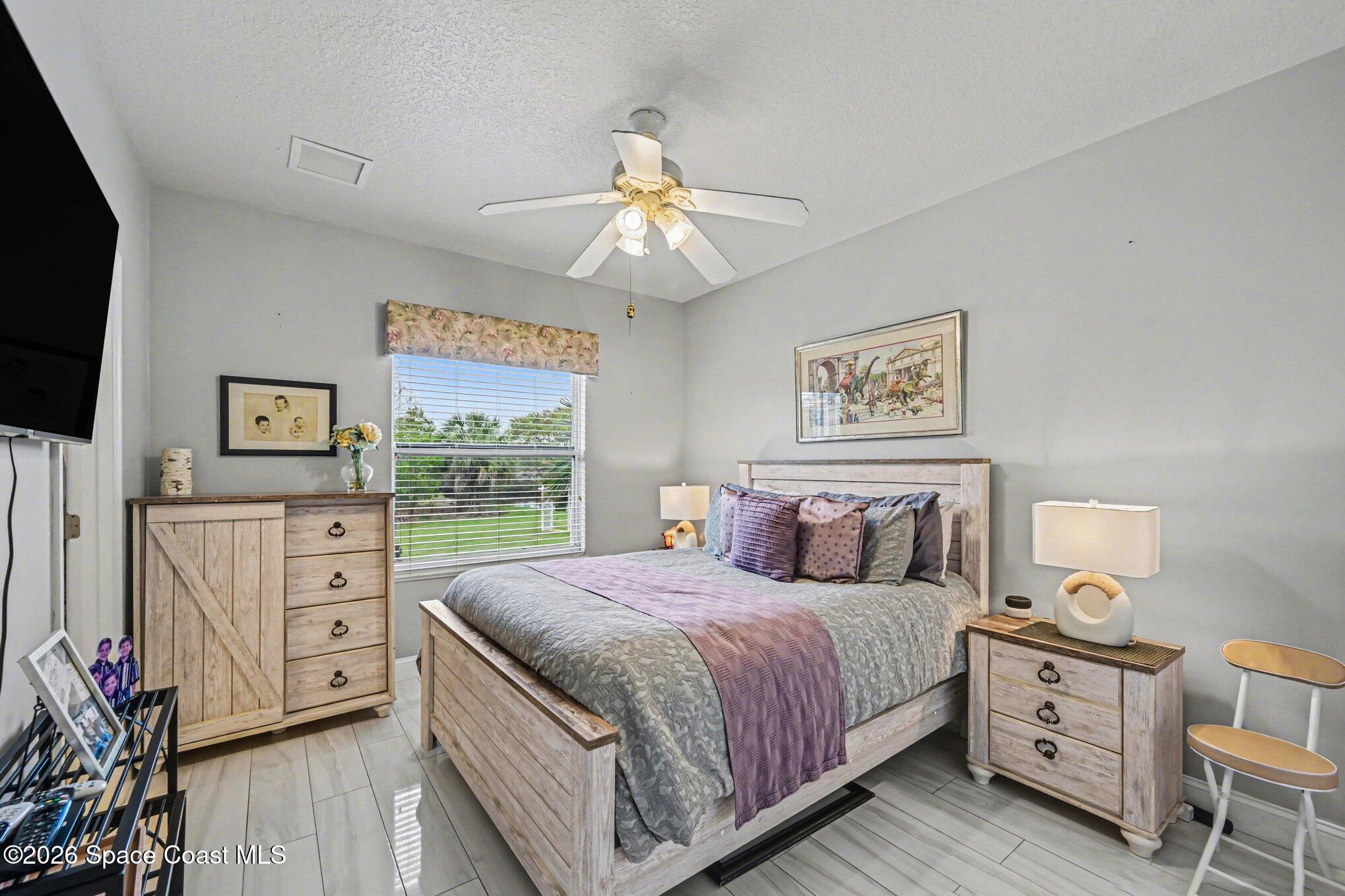 4317 Collingtree Drive Rockledge, FL 32955 - Photo 30 of 64 a bedroom with a large bed and a window