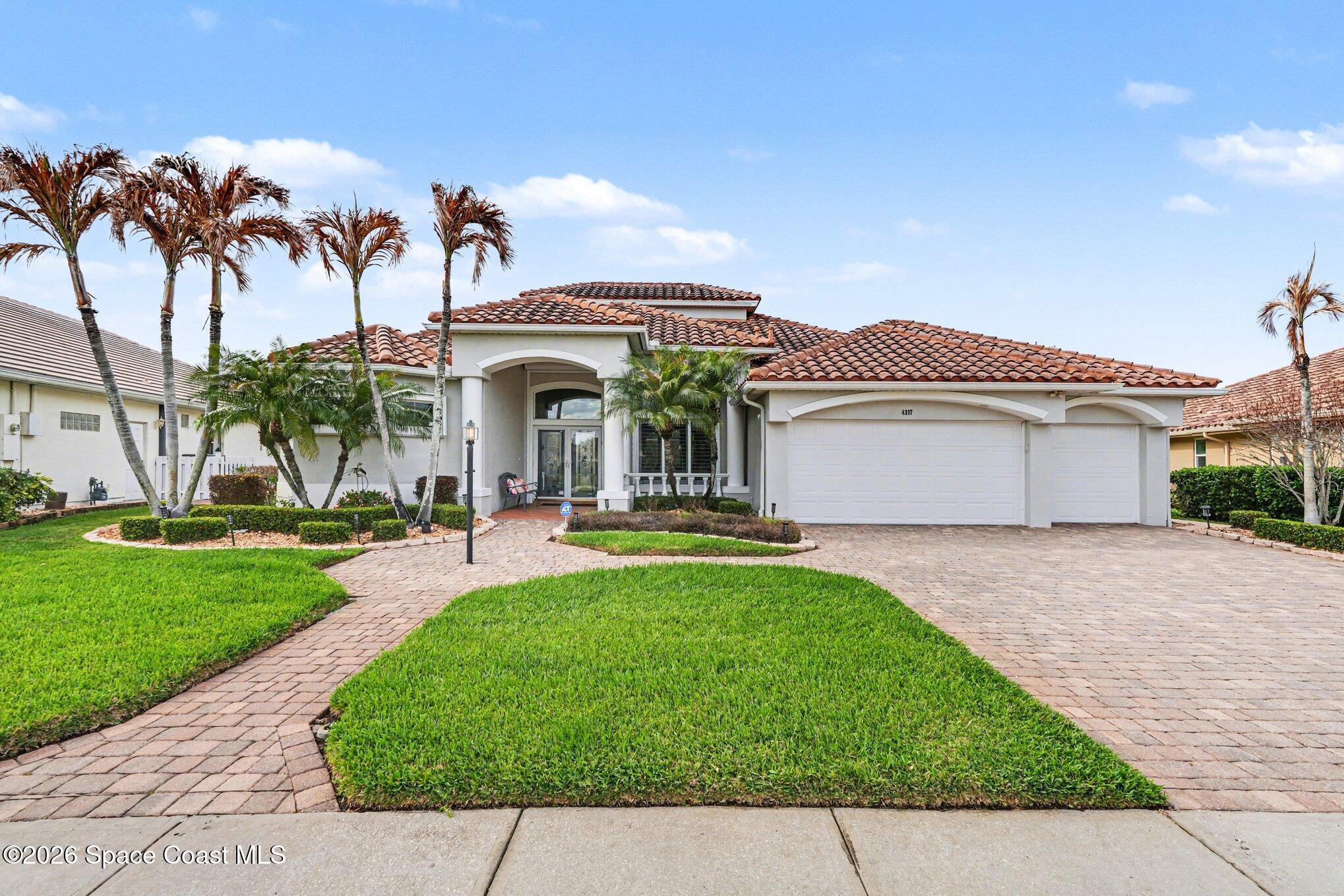 4317 Collingtree Drive Rockledge, FL 32955 - Photo 3 of 64 a front view of a house with a garden and trees