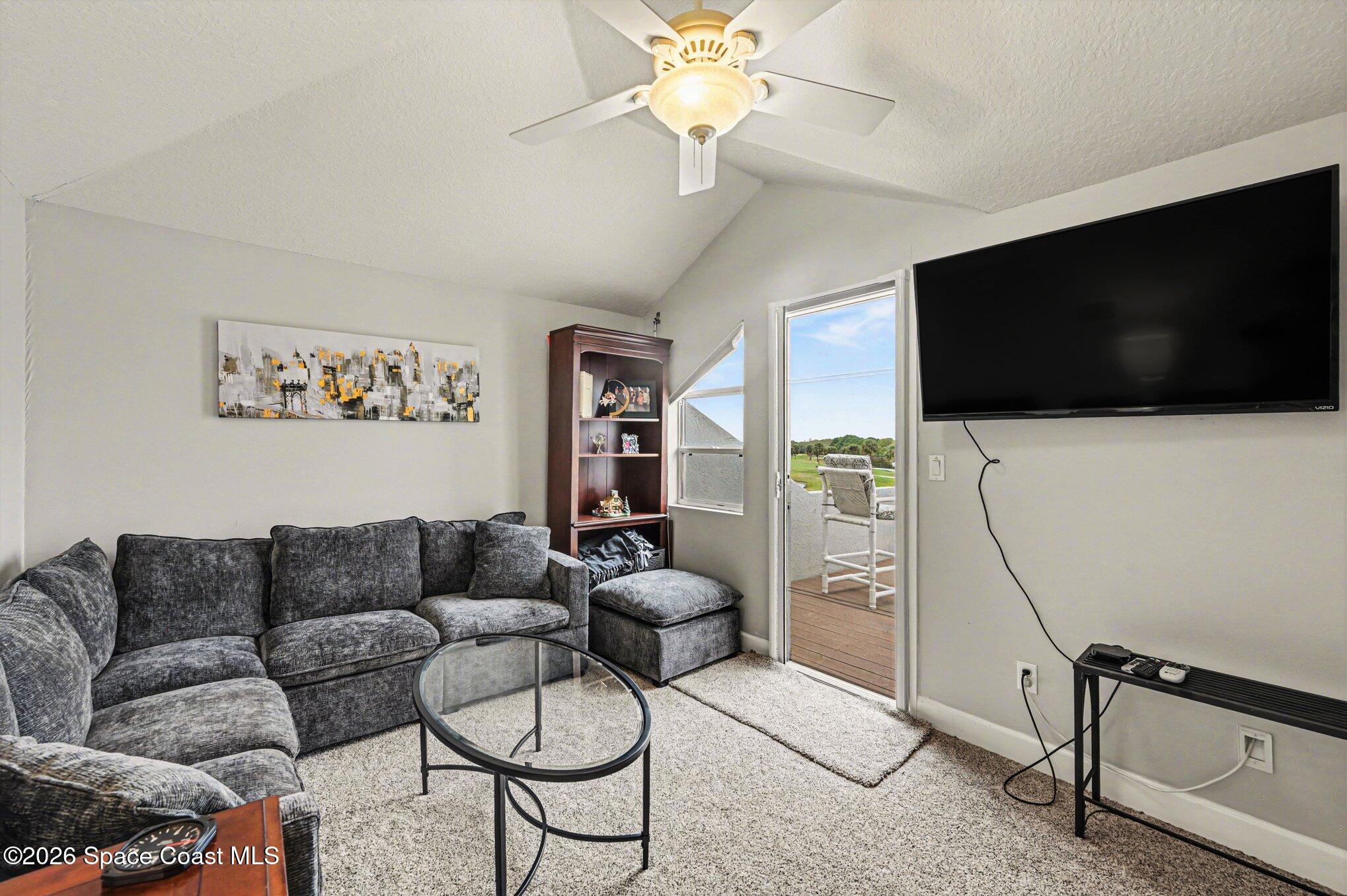 4317 Collingtree Drive Rockledge, FL 32955 - Photo 36 of 64 a living room with furniture and a flat screen tv