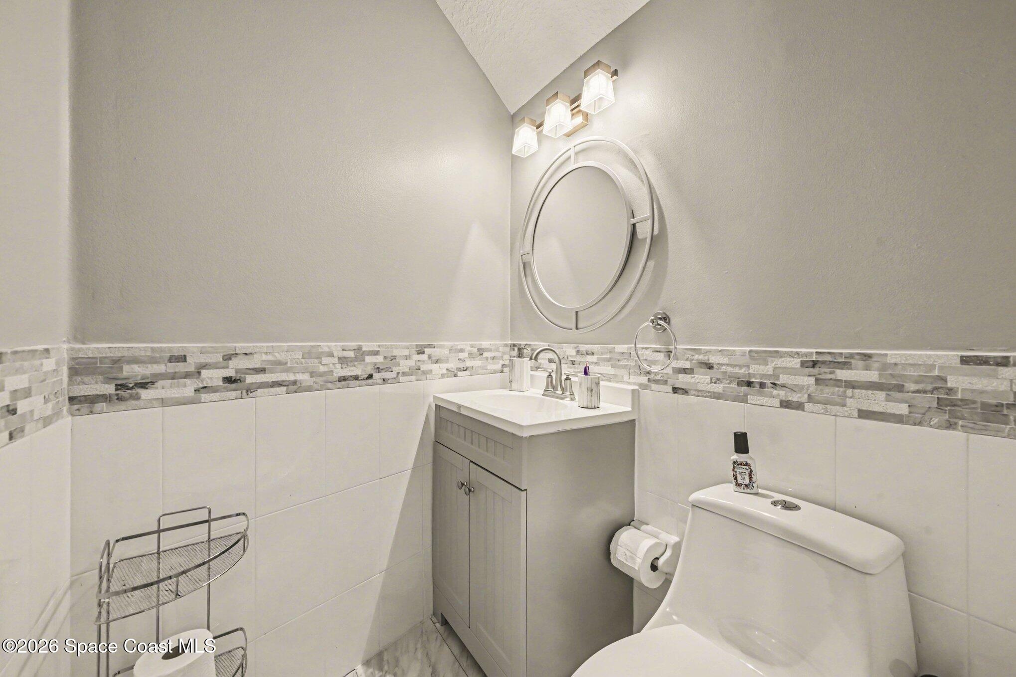 4317 Collingtree Drive Rockledge, FL 32955 - Photo 39 of 64 a bathroom with a sink toilet and mirror