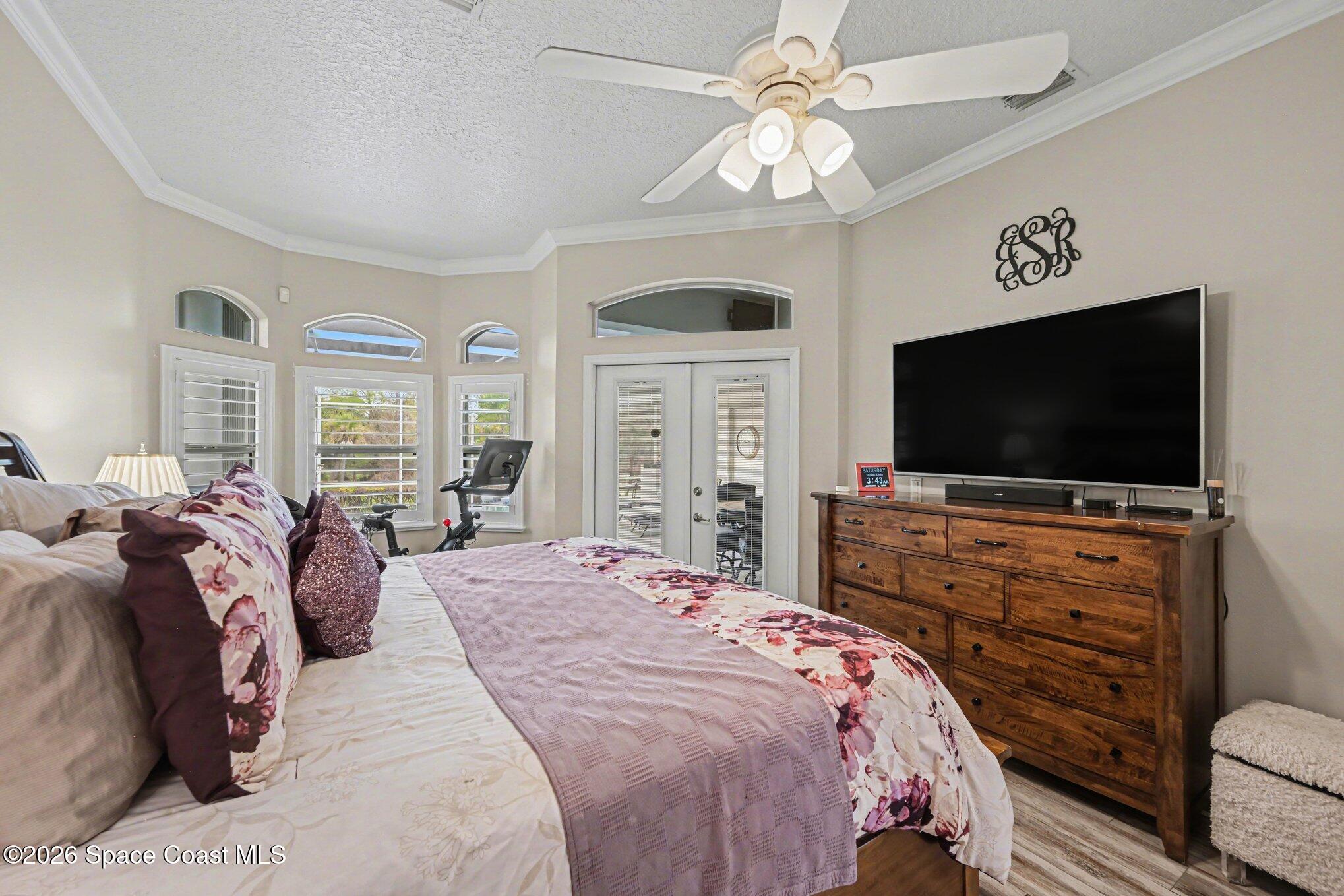 4317 Collingtree Drive Rockledge, FL 32955 - Photo 41 of 64 a bedroom with a bed and a flat screen tv