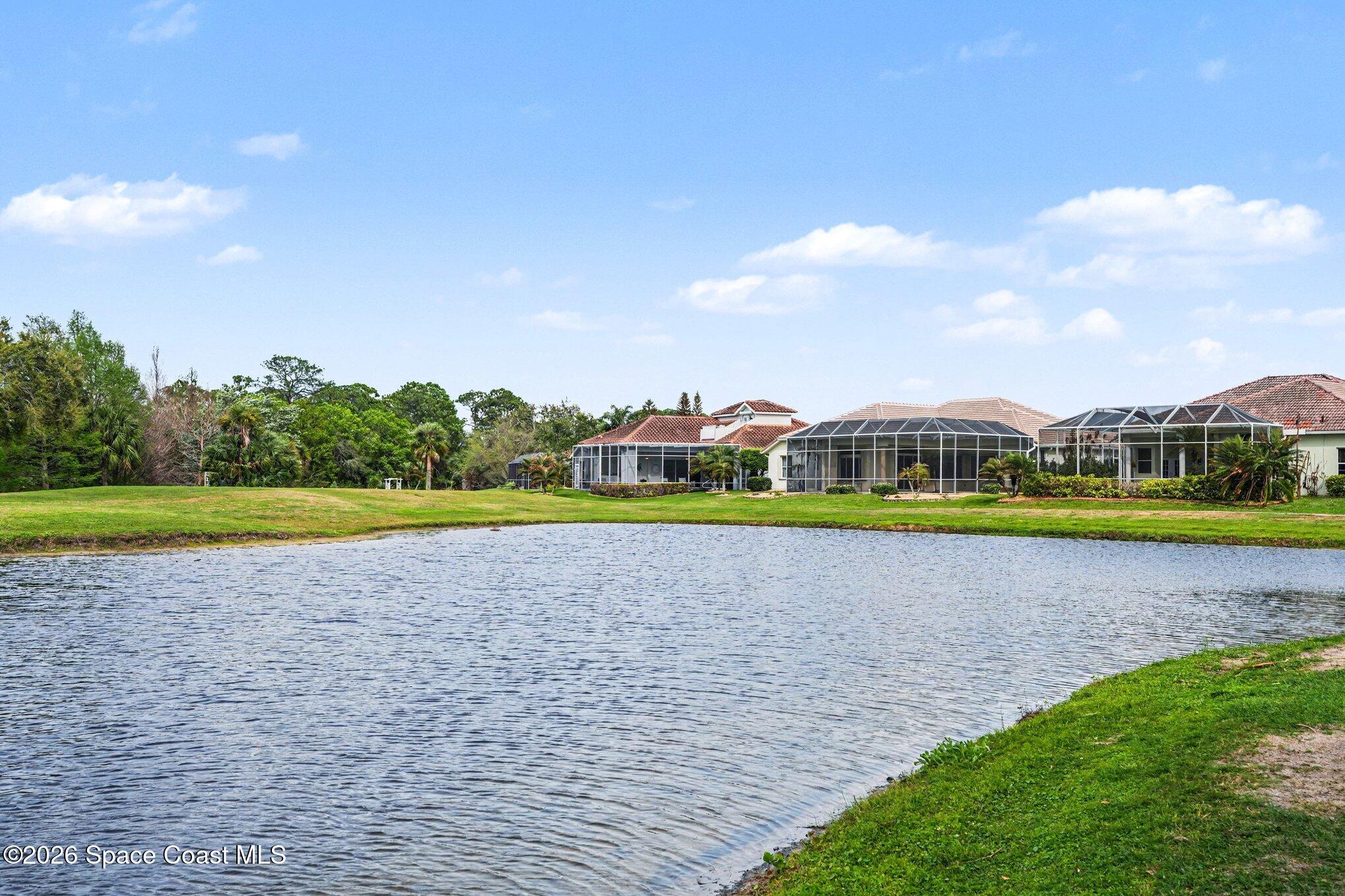 4317 Collingtree Drive Rockledge, FL 32955 - Photo 54 of 64 a view of a golf course with a lake