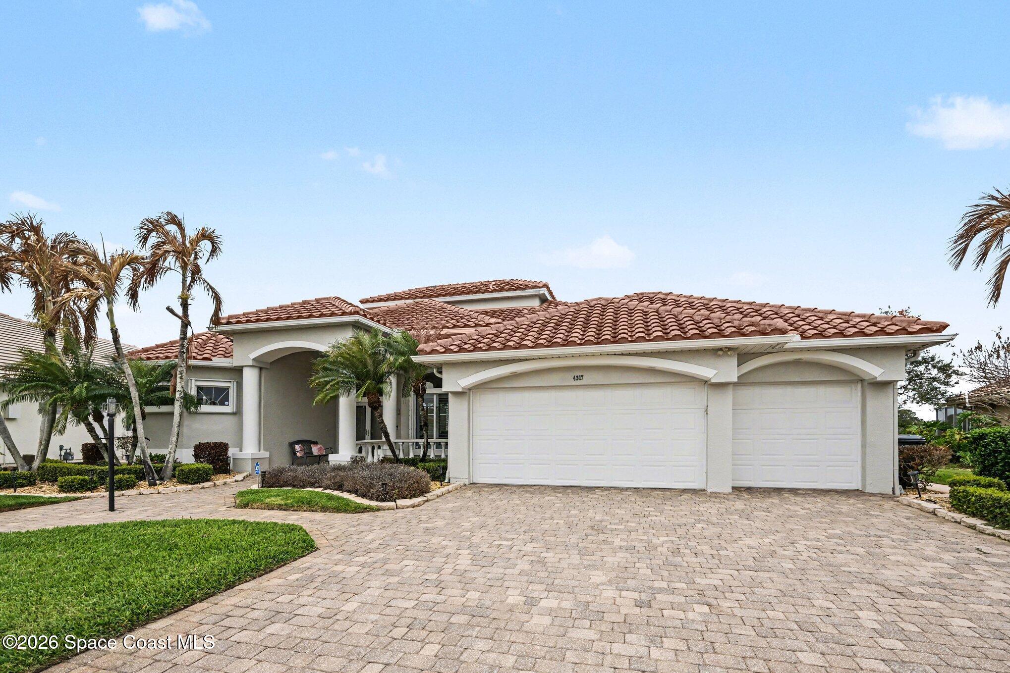 4317 Collingtree Drive Rockledge, FL 32955 - Photo 6 of 64 a front view of a house with a garden and a garage