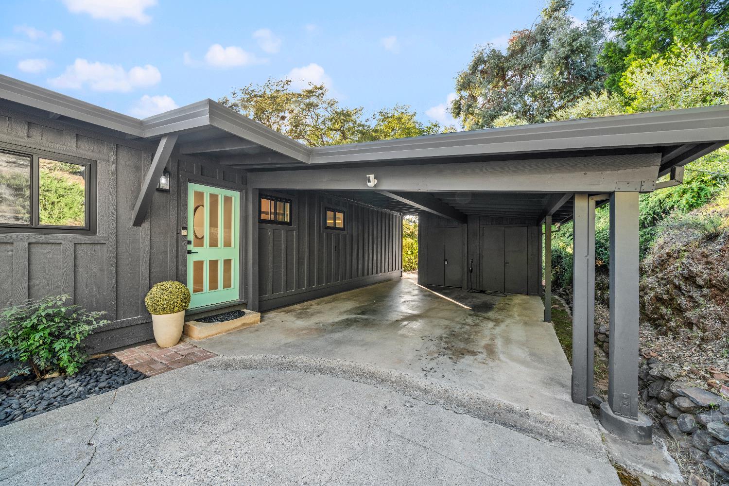 140 Rio Camino Street Auburn, CA 95603 - Photo 2 of 56 a front view of a house with outdoor seating and plants