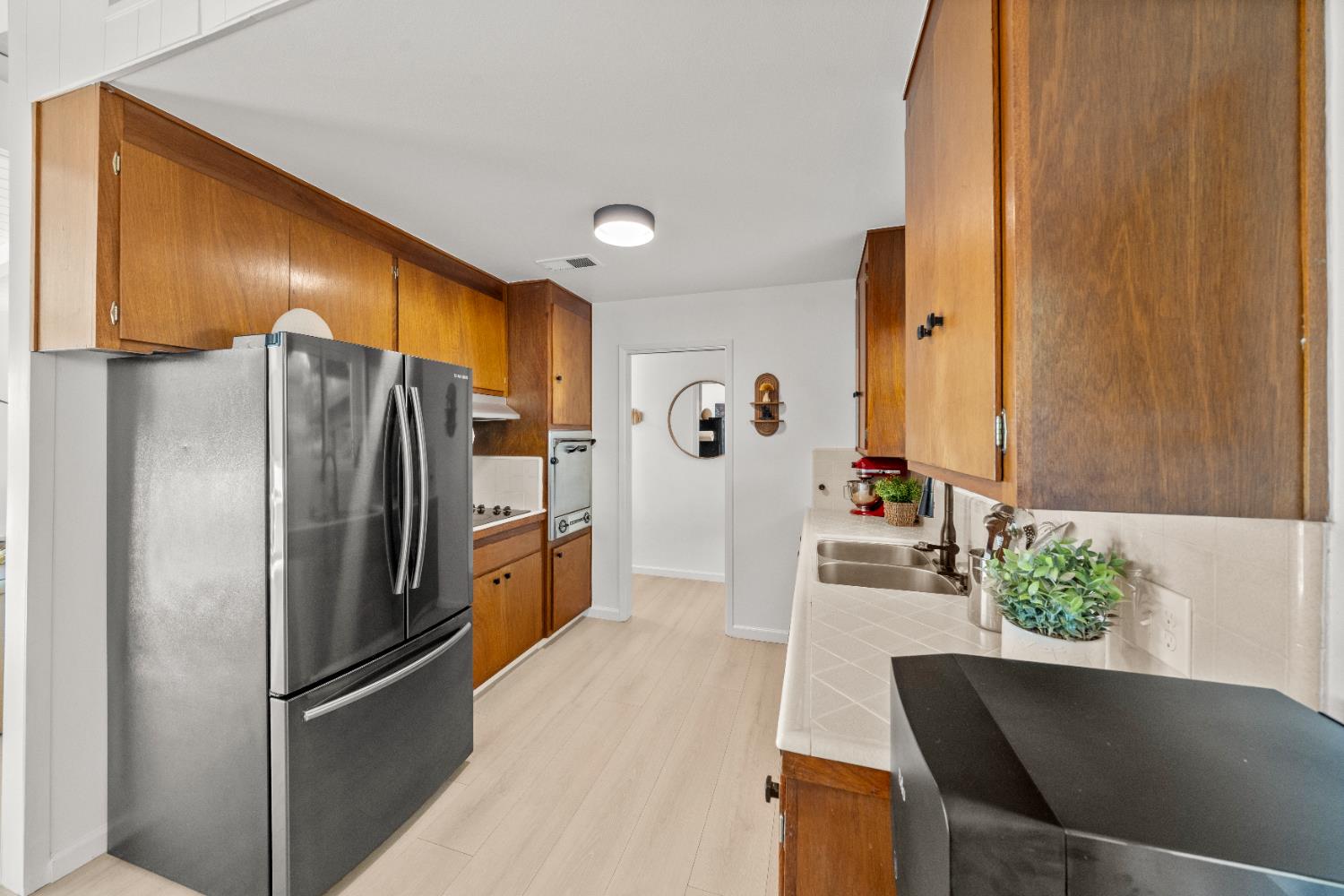140 Rio Camino Street Auburn, CA 95603 - Photo 22 of 56 a kitchen with stainless steel appliances a refrigerator and a counter