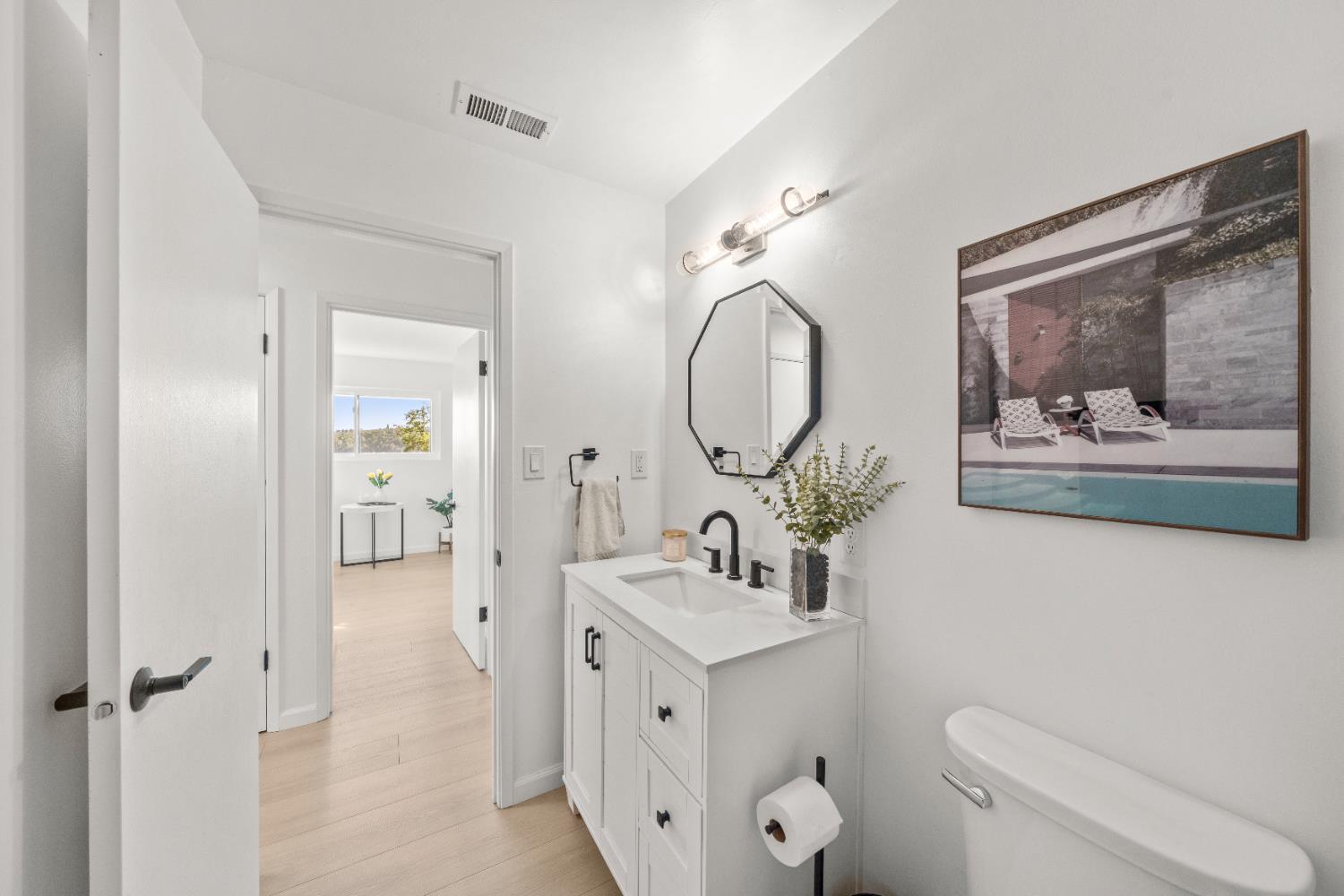 140 Rio Camino Street Auburn, CA 95603 - Photo 28 of 56 a bathroom with a toilet a sink and mirror