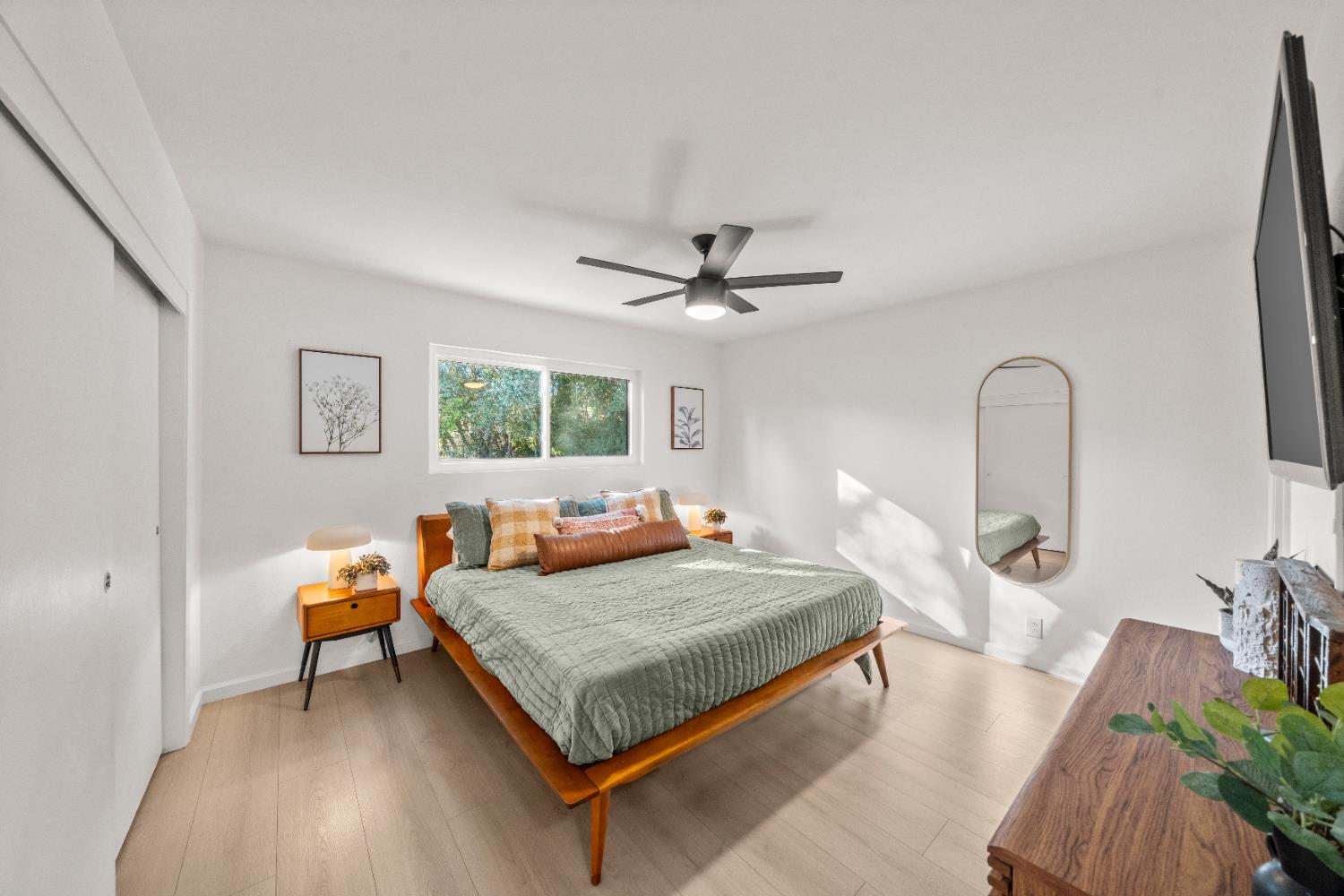 140 Rio Camino Street Auburn, CA 95603 - Photo 36 of 56 a bedroom with a bed and a dresser with mirror