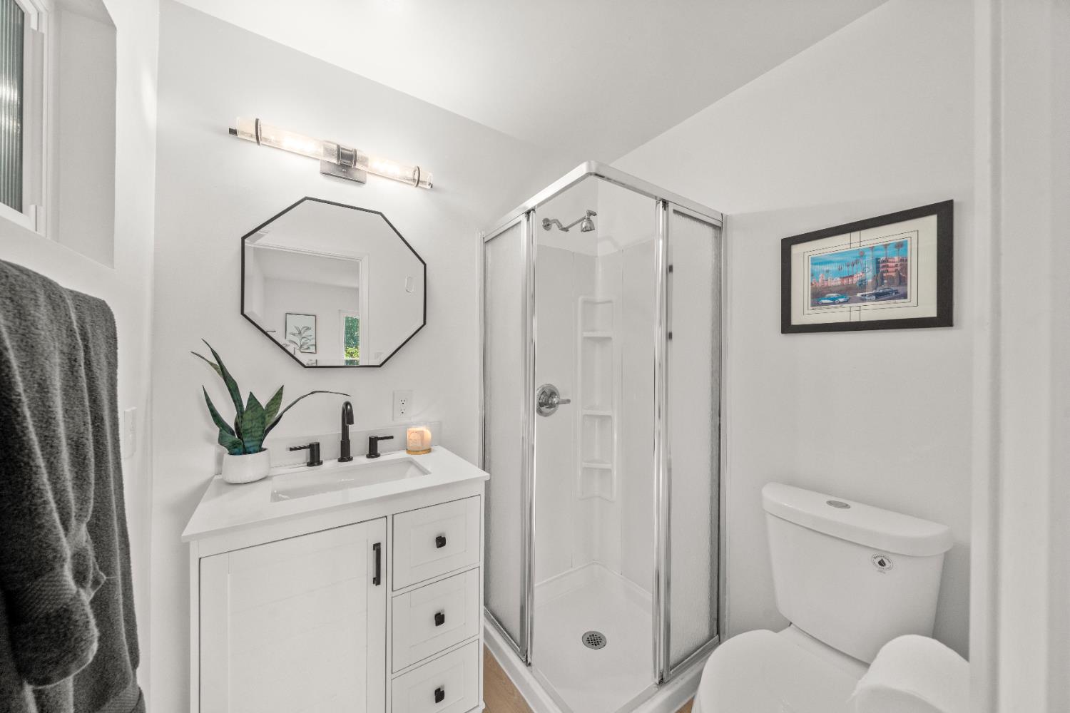 140 Rio Camino Street Auburn, CA 95603 - Photo 39 of 56 a bathroom with a toilet sink vanity granite and a mirror
