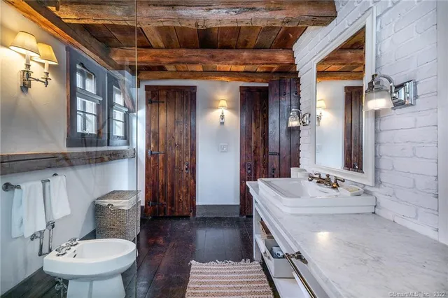 a bedroom with furniture and a fireplace