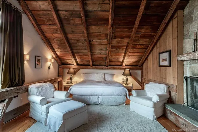a bedroom with a bed couch and window