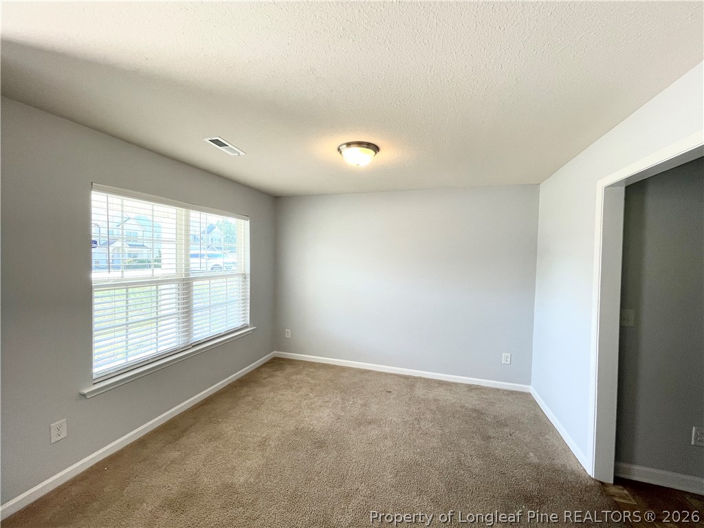92 Hallow Oak Street Spring Lake, NC 28390 - Photo 4 of 11 a view of an empty room with a window