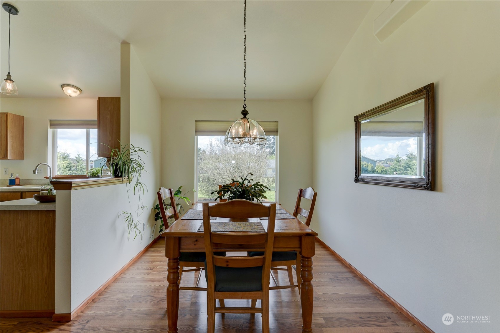 9425 180th Way Southwest Rochester, WA 98579 - Photo 11 of 37 a dining room with furniture a chandelier and wooden floor