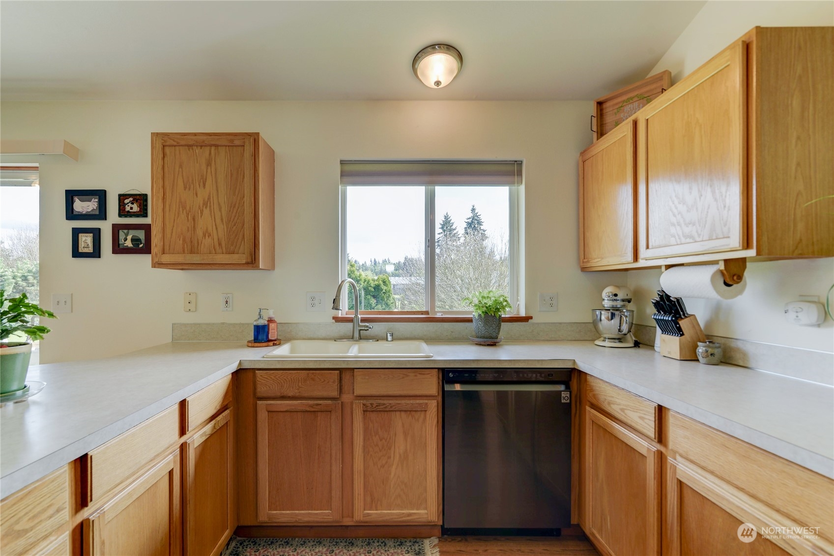 9425 180th Way Southwest Rochester, WA 98579 - Photo 14 of 37 a kitchen with a sink cabinets and window