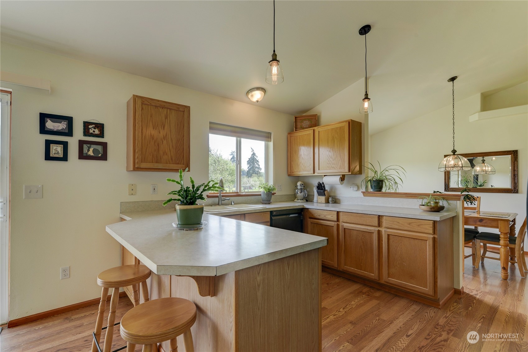 9425 180th Way Southwest Rochester, WA 98579 - Photo 15 of 37 a kitchen with a table chairs sink and cabinets