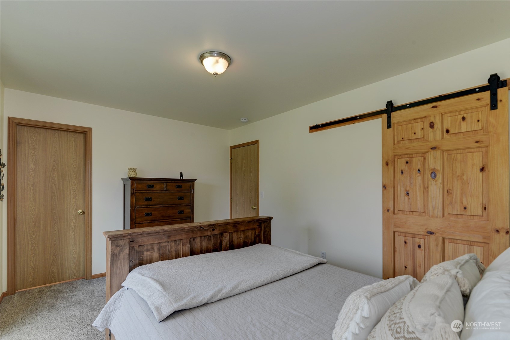9425 180th Way Southwest Rochester, WA 98579 - Photo 23 of 37 a bedroom with a bed and a night stand