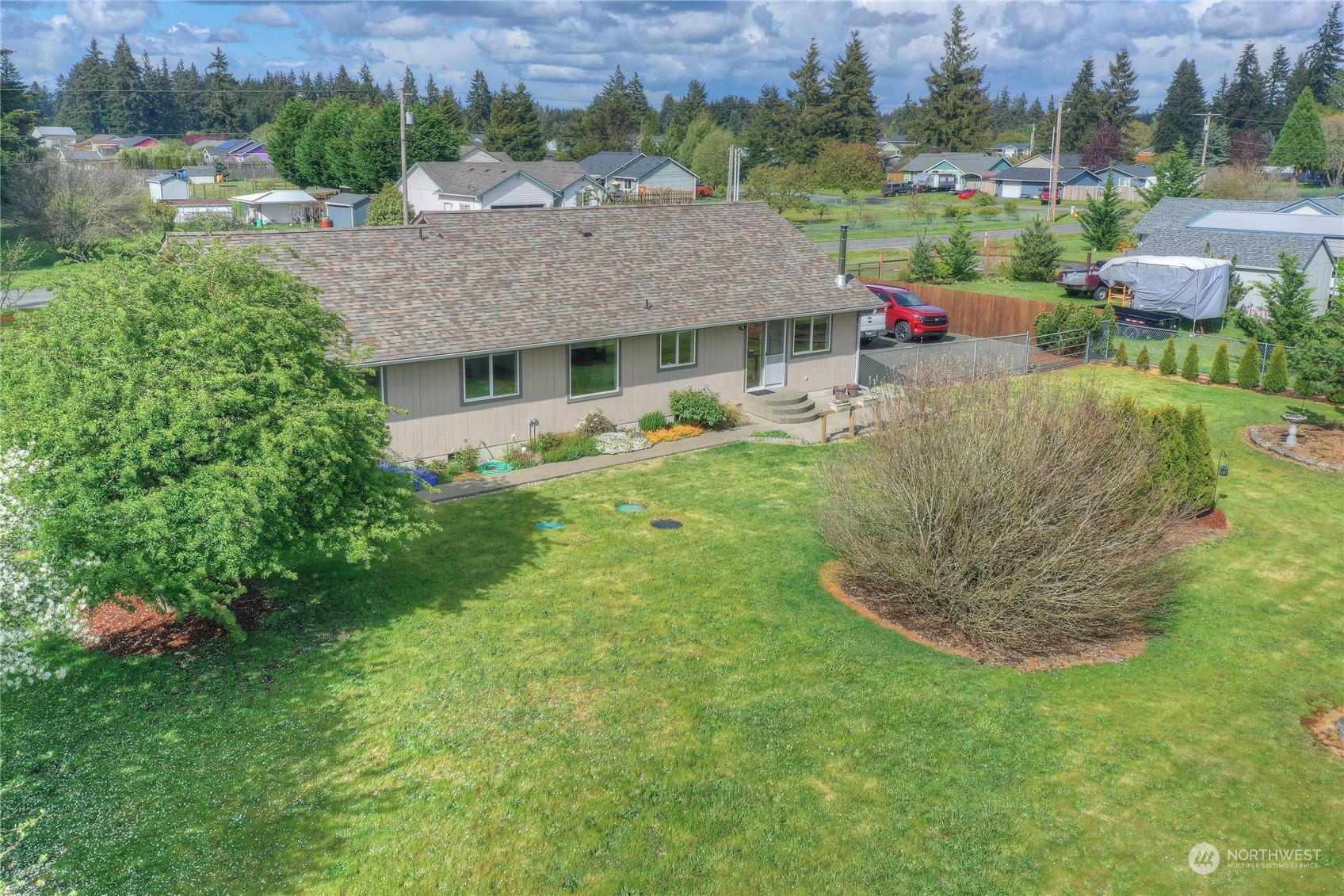9425 180th Way Southwest Rochester, WA 98579 - Photo 30 of 37 a aerial view of a house with a yard table and chairs